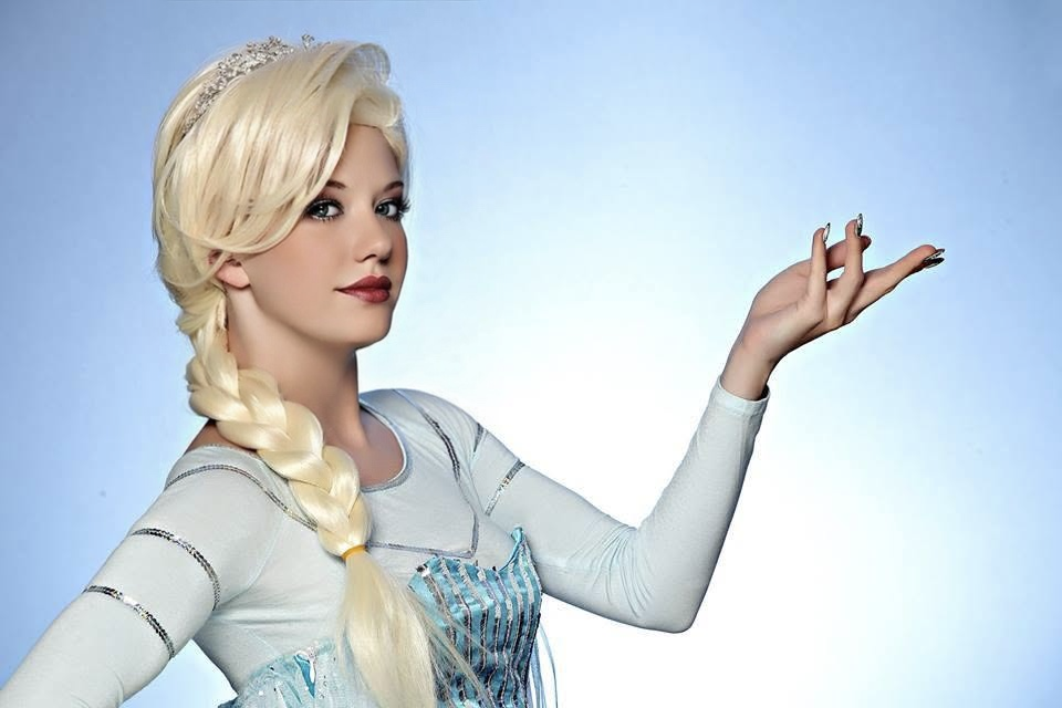 Performer wearing a pale blue winter-inspired gown against an icy blue background